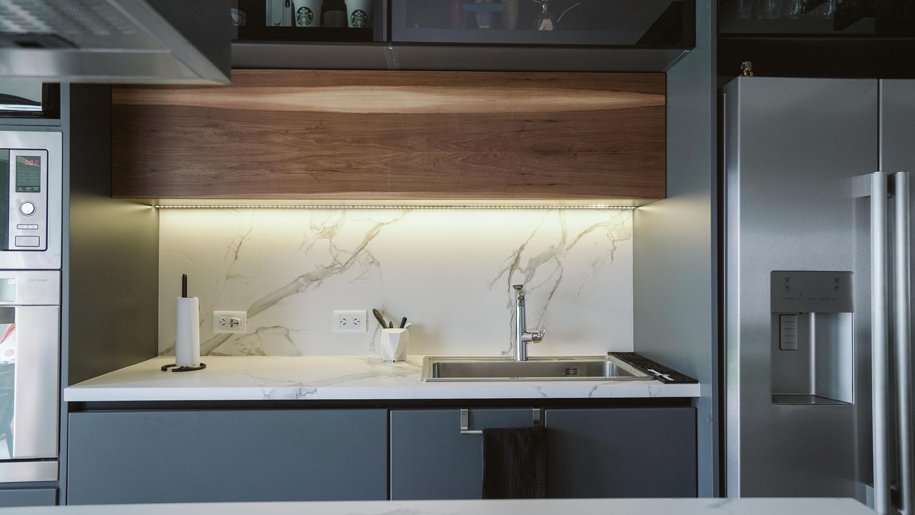 Smart refrigerator display interface in warm wood kitchen