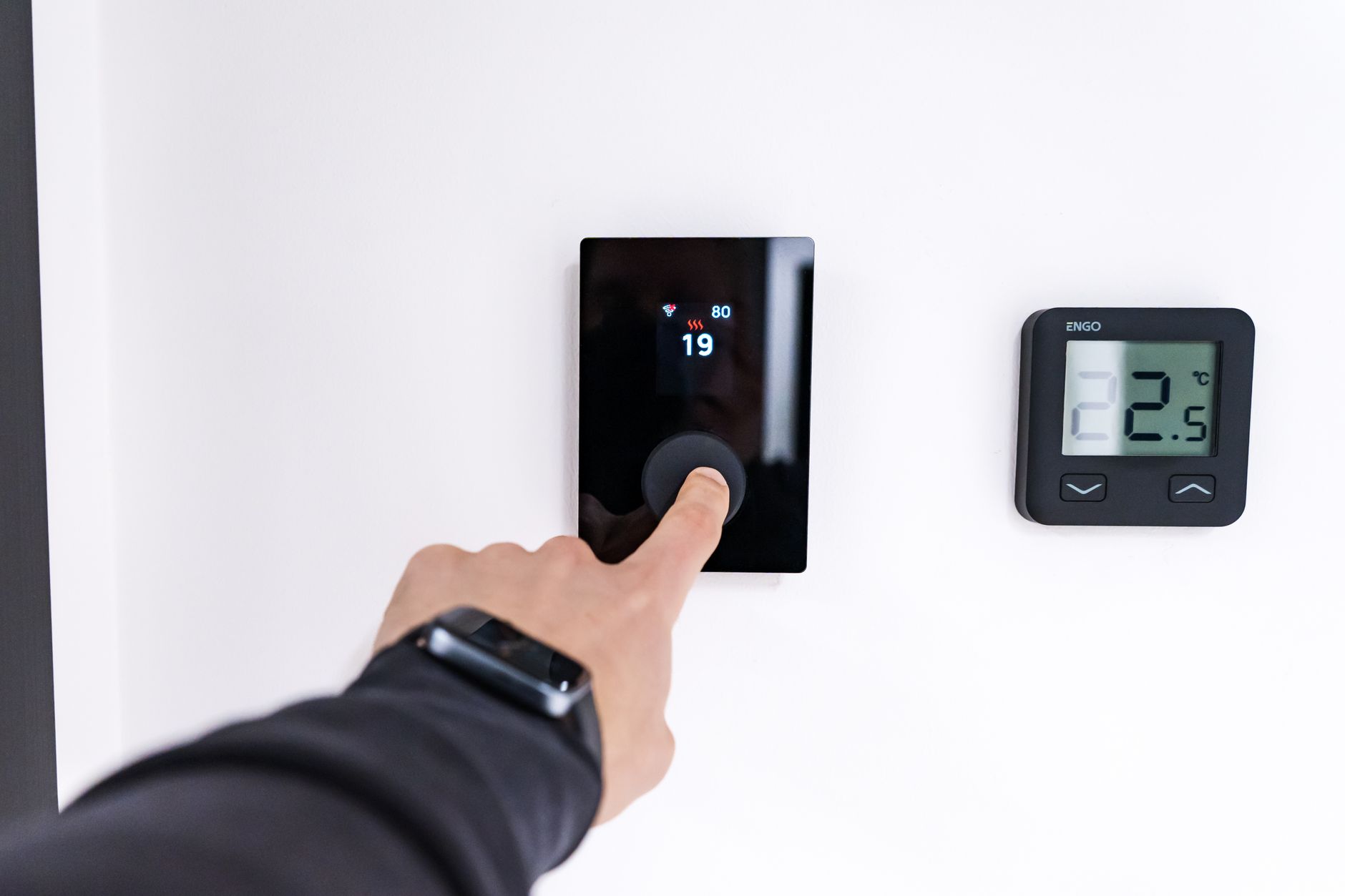 Contemporary climate thermostat controlling minimalist space